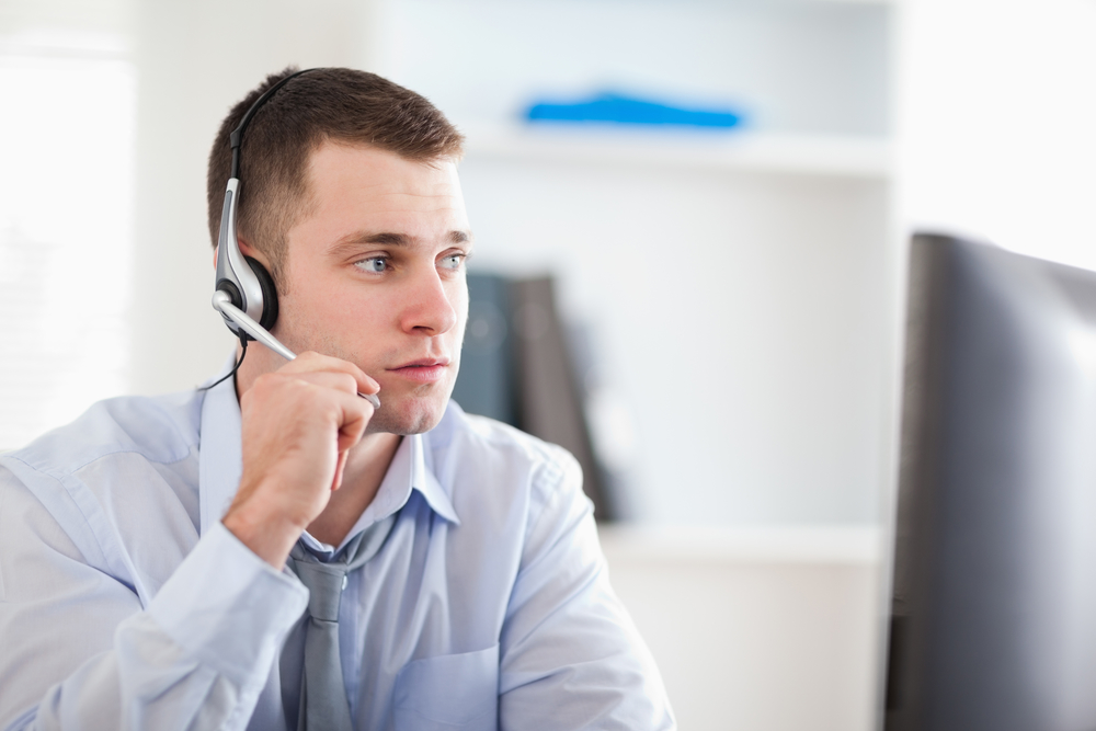 Call center agent speaking with customer Young call center agent speaking with customer